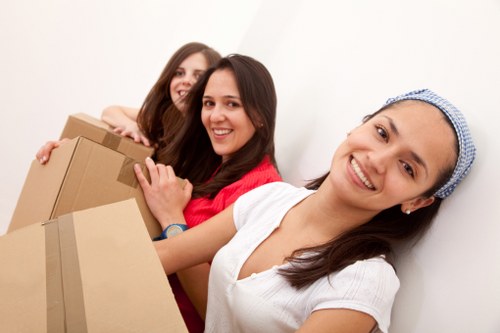 Unpacking household items into a kitchen and living space in Harringay
